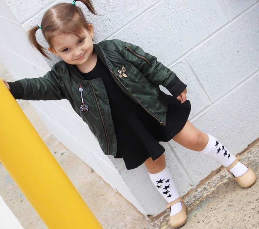 A trendy unisex kids bomber jacket styled for a fashionable look.