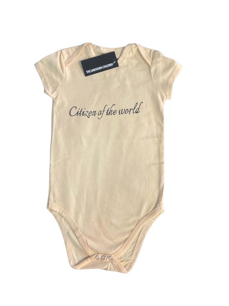 Soft yellow "Citizen of the World" onesie from THE UNKNOWN CHILDREN, 
made from 100% breathable cotton with a branded tag, offering comfort 
and durability for active toddlers.