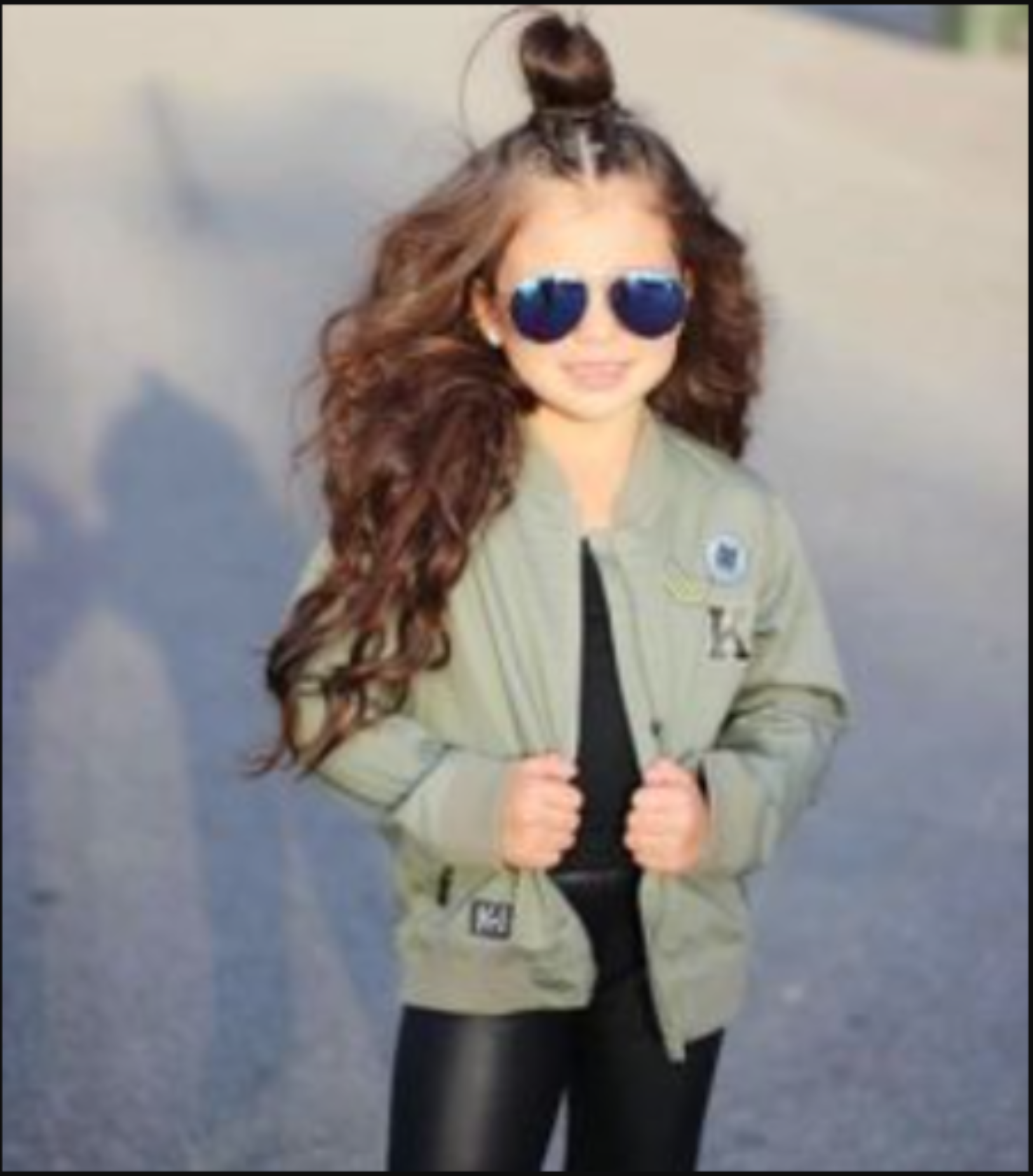 Kardashian Kids wearing a similar khaki bomber jacket, showcasing the stylish, trendy design that inspired THE UNKNOWN CHILDREN’s Unisex Kids Bomber Jacket.